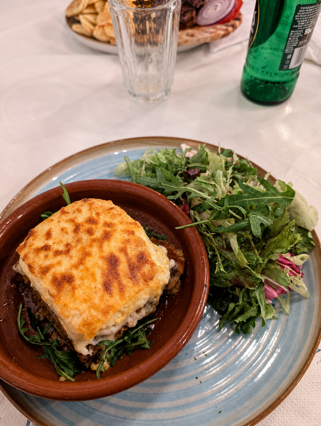 A baked Greek main dish served with salad